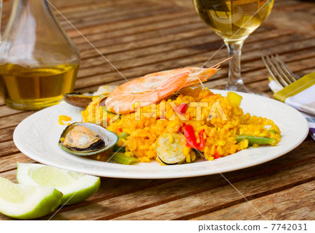 Dining with paella dish Dining with paella dish 7742031