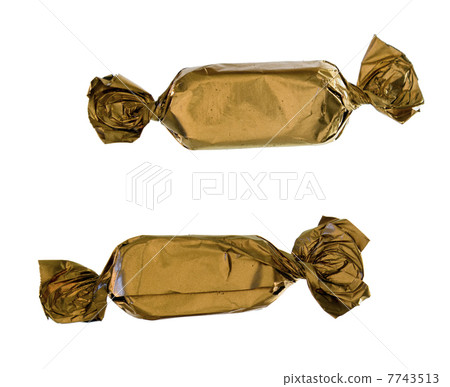 Two gold sweets close-up 7743513