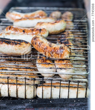 many sausage cooking in grilled barbecue many sausage cooking in grilled barbecue 7745008