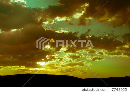 Beautiful sunset in countryside with cloudy sky Beautiful sunset in countryside with cloudy sky 7748055