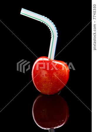 Ripe cherry with cocktail straw 7748380