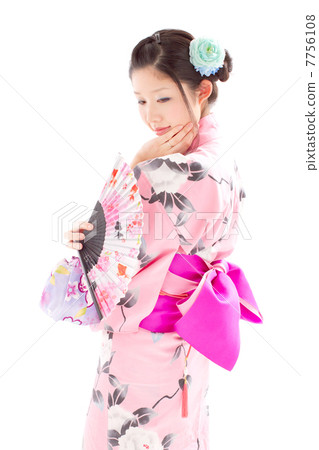 A woman wearing a yukata looking backwards and looking pretty 7756108