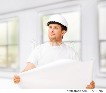 male architect looking at blueprint at home male architect looking at blueprint at home 7756787