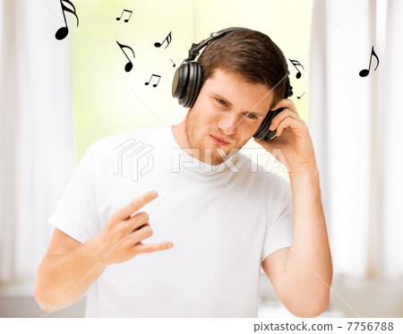 man with headphones listening rock music at home man with headphones listening rock music at home 7756788