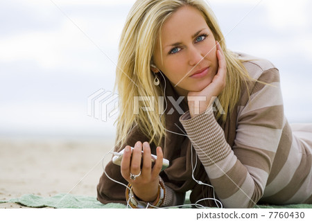 Woman Girl Listening to MP3 Player on Beach 7760430