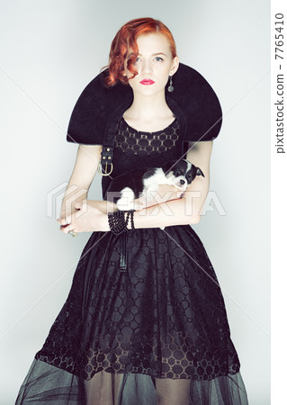 Vintage portrait of a lady with a puppy. Vintage portrait of a lady with a puppy. 7765410