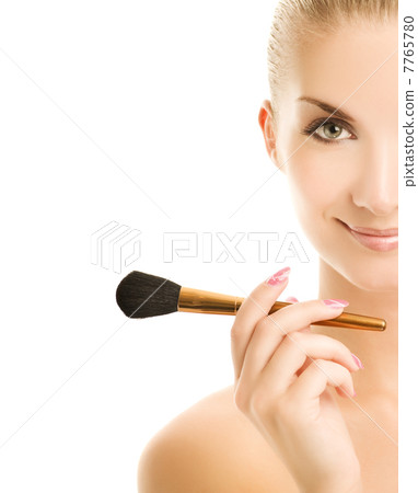 Lovely young woman with a make-up brush. Isolated on white backg Lovely young woman with a make-up brush. Isolated on white backg 7765780