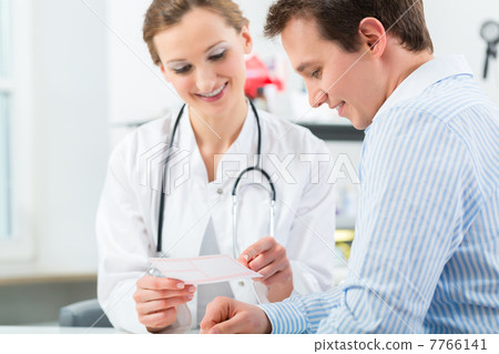 Doctor with patient in clinic consulting