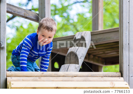 Little Kid on a jungle gym Little Kid on a jungle gym 7766153