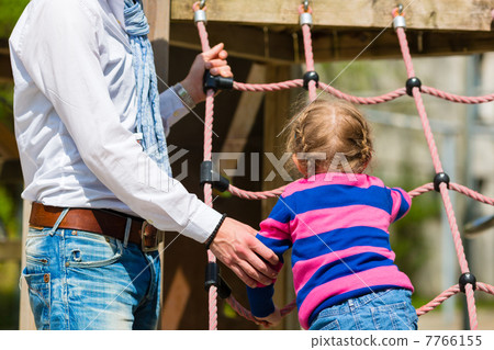 Father and daughter playing on the playground Father and daughter playing on the playground 7766155