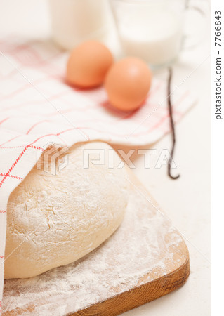 Dough on wooden board 7766843