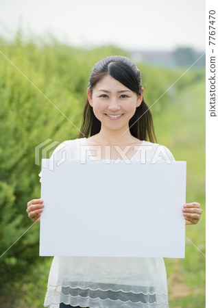 A woman with a message board A woman with a message board 7767470
