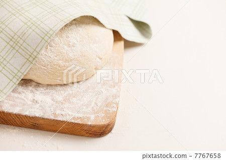 Dough on wooden board 7767658