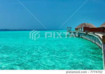 Beautiful beach with water bungalows 7774702