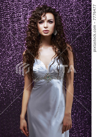 Sophistication. Glamor. Sensual Brunette with Waved Hairs and Silk Blue Dress 7776477