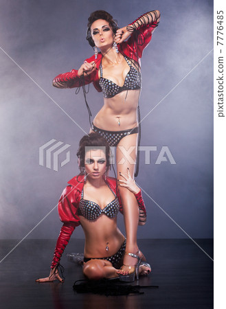 Performance. Couple of Women in Theatrical Costumes. Nightlife Performance. Couple of Women in Theatrical Costumes. Nightlife 7776485