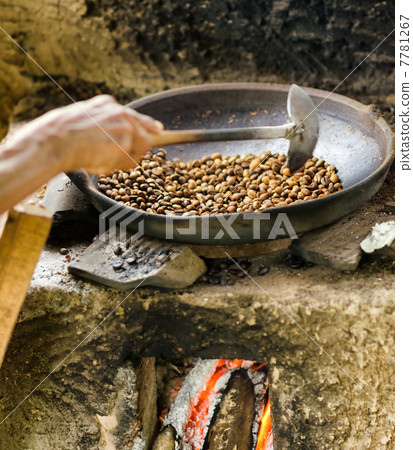 Coffee beans are roasting in pan. Traditional techniques 7781267