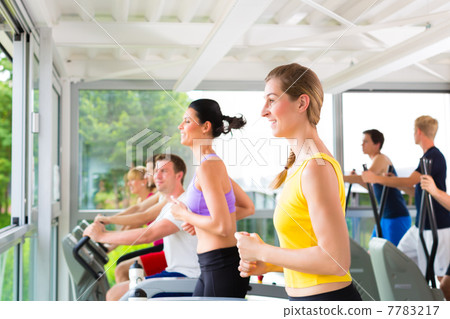 People in sport gym on treadmill running 7783217