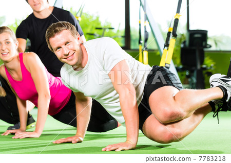 People in sport gym on suspension trainer 7783218