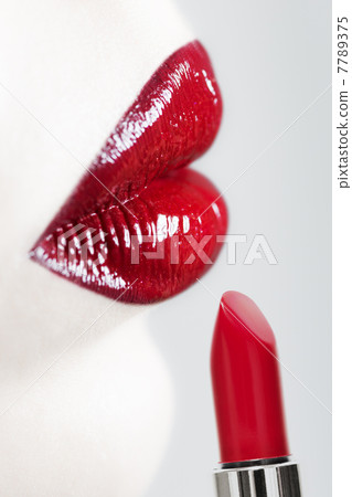 Female lips and lipstick. Vertical shot. 7789375