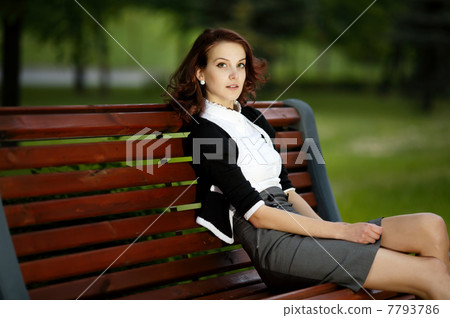 young beautiful girl sitting on bench young beautiful girl sitting on bench 7793786