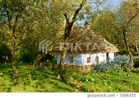 old  house with a thatched roof 7806355
