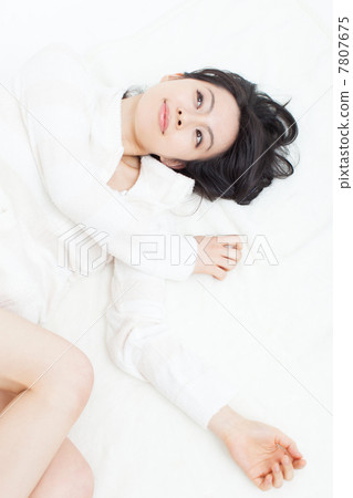 A woman lying on the bed 7807675