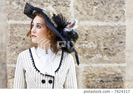 Old-fashioned dressed woman with wandering gaze 7824317