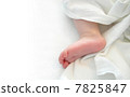 Baby foot over white sheet 7825847
