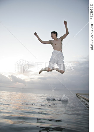 Young man jumping from water 7826438