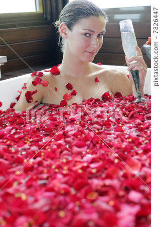 Woman having flower bath 7826447