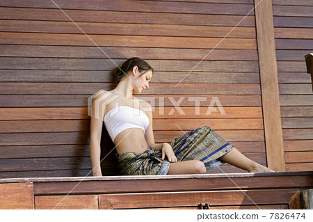 Young woman sitting on wood stage 7826474