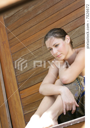 Young woman sitting with smile 7826672