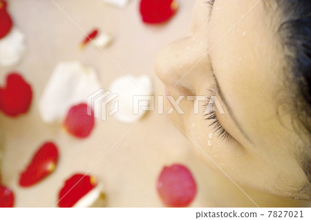 High angle view of young woman having flower shower High angle view of young woman having flower shower 7827021