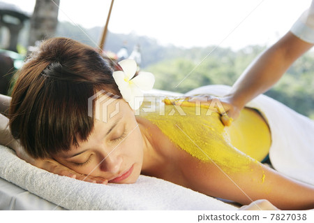 Womon lying on massage table outdoors Womon lying on massage table outdoors 7827038