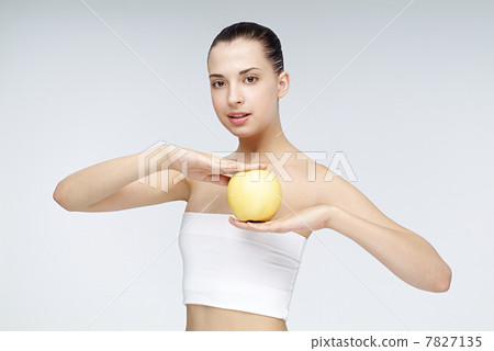 Close-up of young woman holding an apple Close-up of young woman holding an apple 7827135