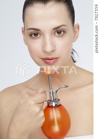Young woman holding a small watering can 7827359
