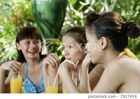 Three young women drinking juice Three young women drinking juice 7827458