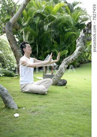 Young man practising Qigong Young man practising Qigong 7827459