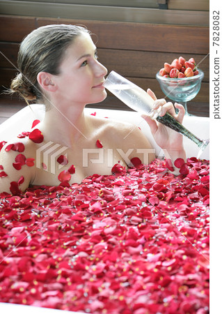Woman having flower bath 7828082