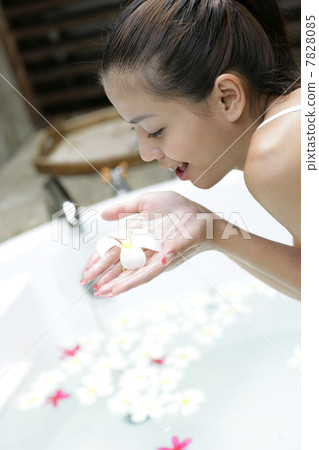 Young woman holding petals in hands 7828085