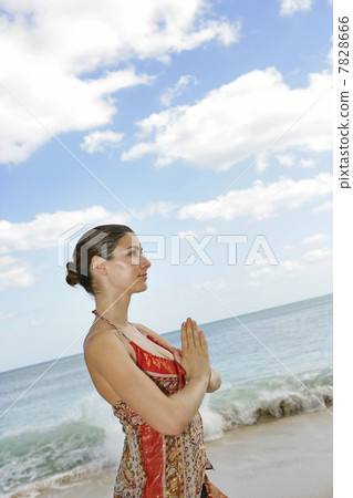 Young woman practicing yoga on the beach 7828666