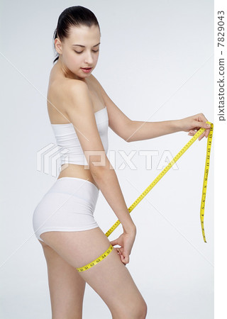 Young woman holding tape measuring 7829043