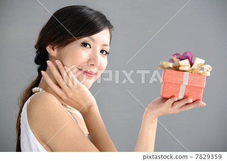 Young woman holding gift box 7829359
