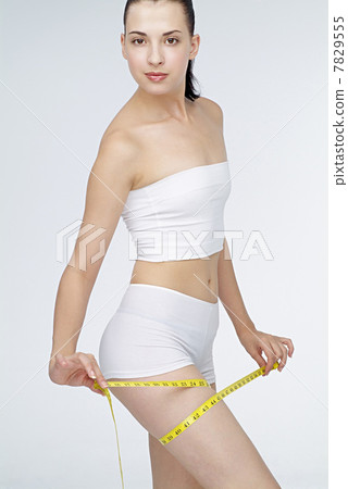 Young woman holding tape measuring 7829555