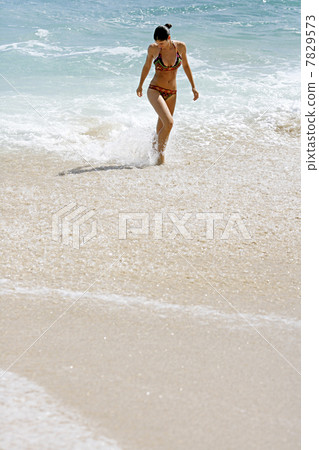 Young woman standing in the sea 7829573
