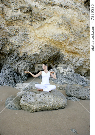 Young woman practicing yoga on the beach 7829586