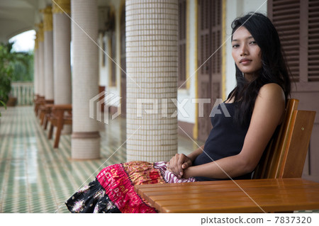 woman sitting on a bench in the hallway 7837320