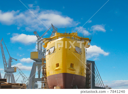 The construction of a new ship in dry dock shipyard The construction of a new ship in dry dock shipyard 7841240