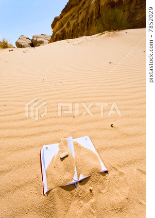 office note book in red sand of desert 7852029